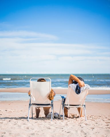 Two people relaxing in beach chairs