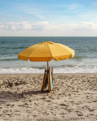 Yellow beach umbrella and chairs on the shore